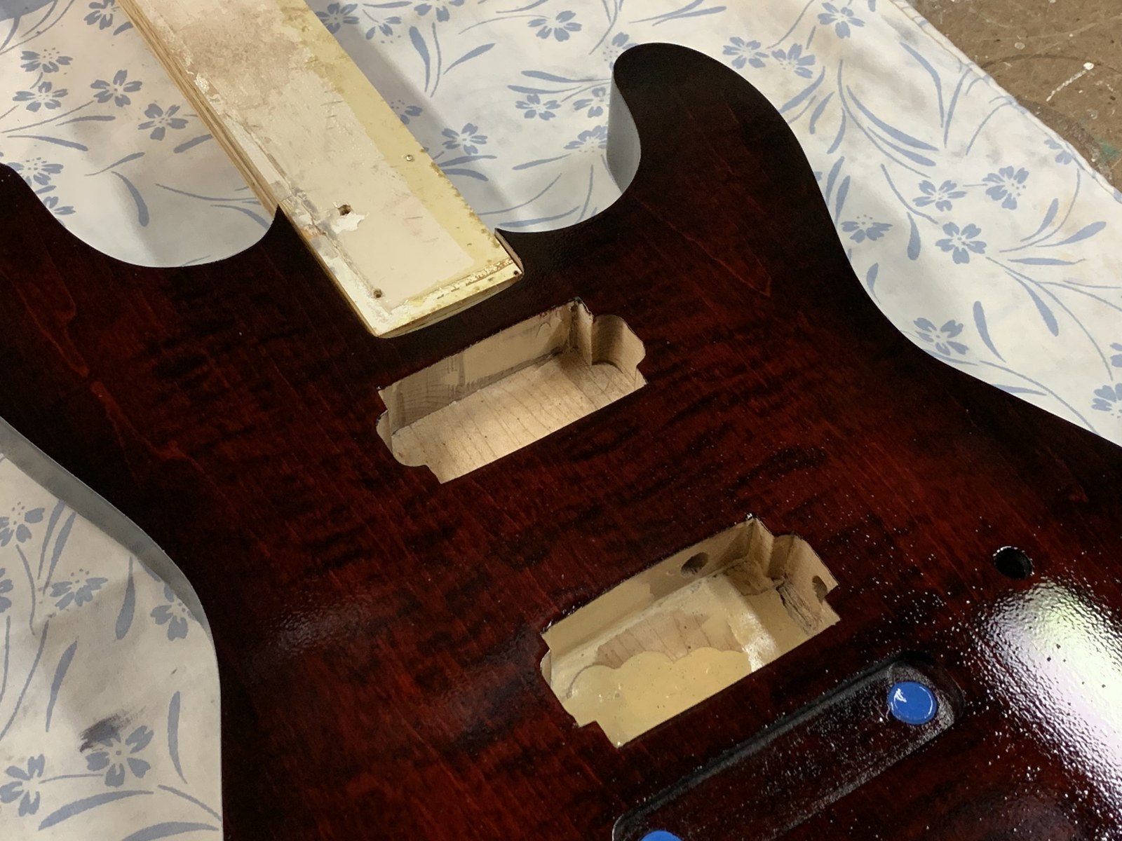 Glossy red guitar body close-up before final assembly