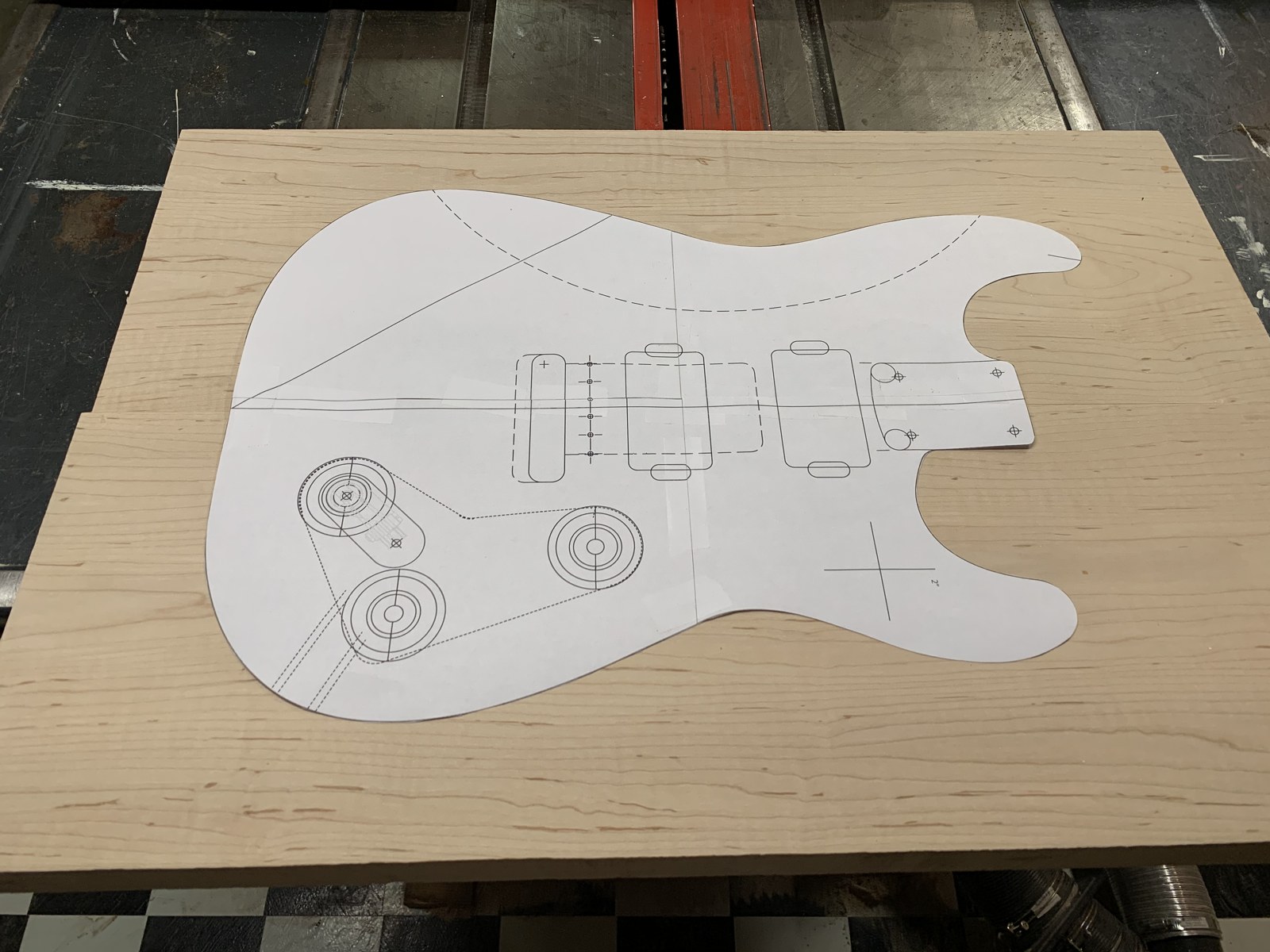 Paper guitar body and electronics pattern on a wooden blank